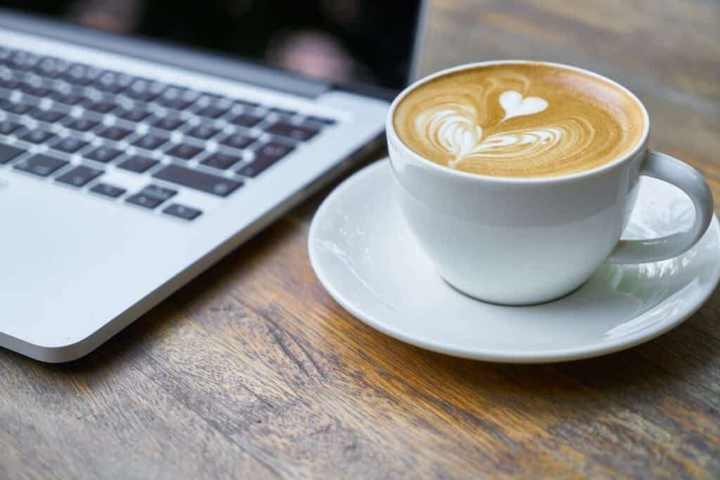Coffee next to laptop