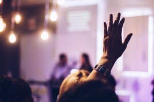 Photo of a hand raised asking a Question